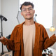Young Asian Photographer in Glasses Holding Camera Body and Lens in His Bright Photo Studio Young Asian Photographer in Glasses Holding Camera Body and Lens in His Bright Photo Studio - PhotoDune Item for Sale