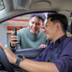 Young Man Shows His Smartphone Screen to Friendly Male Online Car Driver Young Man Shows His Smartphone Screen to Friendly Male Online Car Driver - PhotoDune Item for Sale