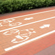 Two-way bicycle path made of red paving stones with white road markings.Traffic for bicycles. Two-way bicycle path made of red paving stones with white road markings.Traffic for bicycles. - PhotoDune Item for Sale