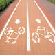 Two-way bicycle path on paving stones in the park. Traffic for bicycles. City infrastructure Two-way bicycle path on paving stones in the park. Traffic for bicycles. City infrastructure - PhotoDune Item for Sale