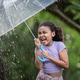 Young Girl Holding Transparent Umbrella During Rainy Season in Tropical Nature Young Girl Holding Transparent Umbrella During Rainy Season in Tropical Nature - PhotoDune Item for Sale