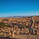 Man pointing at the panoramic view of the ancient ksar of Ait Ben Haddou. Man pointing at the panoramic view of the ancient ksar of Ait Ben Haddou. - PhotoDune Item for Sale