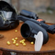 A composition of a military helmet, a weapon and a pistol magazine on a barrel A composition of a military helmet, a weapon and a pistol magazine on a barrel - PhotoDune Item for Sale
