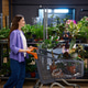 Cheerful woman with curly hair shopping for indoor greenery in a plant store Cheerful woman with curly hair shopping for indoor greenery in a plant store - PhotoDune Item for Sale