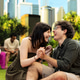 Young couple laughing face to face while holding hands on picnic blanket Young couple laughing face to face while holding hands on picnic blanket - PhotoDune Item for Sale