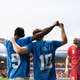 Soccer teammates celebrating winning goal with raised arms Soccer teammates celebrating winning goal with raised arms - PhotoDune Item for Sale