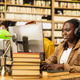 Woman student wearing headphones while working at desktop computer Woman student wearing headphones while working at desktop computer - PhotoDune Item for Sale