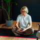 Middle aged woman using phone for setting mobile app for meditation at home, sitting on yoga mat in Middle aged woman using phone for setting mobile app for meditation at home, sitting on yoga mat in - PhotoDune Item for Sale