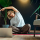 Middle aged woman practicing online yoga workout using laptop in modern Scandi dark interior home. H Middle aged woman practicing online yoga workout using laptop in modern Scandi dark interior home. H - PhotoDune Item for Sale
