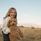 Happy smiling girl with puppy outdoors Happy smiling girl with puppy outdoors - PhotoDune Item for Sale