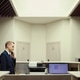 Middle Aged Man Working at Hotel Reception Desk on Phone Middle Aged Man Working at Hotel Reception Desk on Phone - PhotoDune Item for Sale