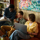 Diverse Adult Friends Collaborating on Tablet and Laptop at Home Diverse Adult Friends Collaborating on Tablet and Laptop at Home - PhotoDune Item for Sale