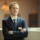 Portrait of Male Hotel Manager Standing at Reception Desk Portrait of Male Hotel Manager Standing at Reception Desk - PhotoDune Item for Sale