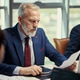 Senior Businessman Reviewing Report during Oil Industry Meeting Senior Businessman Reviewing Report during Oil Industry Meeting - PhotoDune Item for Sale