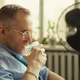 Middle Aged Man Drinking Water near Fan during Office Heat Middle Aged Man Drinking Water near Fan during Office Heat - PhotoDune Item for Sale