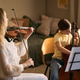 Woman Teaching Girl Playing String Instruments during Music Lesson Woman Teaching Girl Playing String Instruments during Music Lesson - PhotoDune Item for Sale