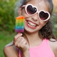 Child holding rainbow popsicle outdoors on sunny summer day, colorful frozen dessert close-up Child holding rainbow popsicle outdoors on sunny summer day, colorful frozen dessert close-up - PhotoDune Item for Sale