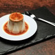 Delicious Panna Cotta Served on a Plate With Smooth Caramel Sauce at a Dining Table Delicious Panna Cotta Served on a Plate With Smooth Caramel Sauce at a Dining Table - PhotoDune Item for Sale