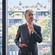 Portrait of male White senior business CEO standing at office window. Portrait of male White senior business CEO standing at office window. - PhotoDune Item for Sale