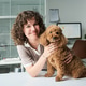 Portrait of Adult Woman Holding Poodle in Vet Office Portrait of Adult Woman Holding Poodle in Vet Office - PhotoDune Item for Sale