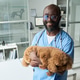 Portrait of Black Male Veterinarian Holding Calm Dog for Pet Care Portrait of Black Male Veterinarian Holding Calm Dog for Pet Care - PhotoDune Item for Sale