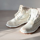 Pair of white canvas boots on wooden table. Pair of white canvas boots on wooden table. - PhotoDune Item for Sale