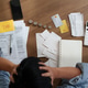 Stressed person holding head in hands over tax forms and calculator on desk for financial anxiety Stressed person holding head in hands over tax forms and calculator on desk for financial anxiety - PhotoDune Item for Sale