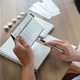 Over the shoulder view of person checking calendar for tax deadline Over the shoulder view of person checking calendar for tax deadline - PhotoDune Item for Sale