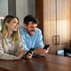 Young happy couple using phone to share social media news at home, doing shopping online. Young happy couple using phone to share social media news at home, doing shopping online. - PhotoDune Item for Sale
