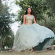 Young woman lifting formal gown in garden during celebration Young woman lifting formal gown in garden during celebration - PhotoDune Item for Sale
