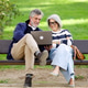 Senior couple using laptop sitting on park bench Senior couple using laptop sitting on park bench - PhotoDune Item for Sale