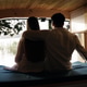 Couple relaxing in camper van looking at lake view Couple relaxing in camper van looking at lake view - PhotoDune Item for Sale