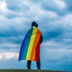 Non-binary person waving LGTB flag in the meadow. LGBT pride concept. Non-binary person waving LGTB flag in the meadow. LGBT pride concept. - PhotoDune Item for Sale