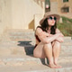 Woman with vitiligo enjoying sun on summer steps Woman with vitiligo enjoying sun on summer steps - PhotoDune Item for Sale