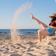 Woman with vitiligo kicking sand on sunny beach Woman with vitiligo kicking sand on sunny beach - PhotoDune Item for Sale