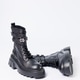 Women's shoes on a white background. Close-up of women's black leather boots with buckles on a white Women's shoes on a white background. Close-up of women's black leather boots with buckles on a white - PhotoDune Item for Sale
