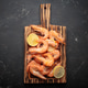 Cooked boiled shrimps lemon slices cutting board seafood dark background appetizer snack Cooked boiled shrimps lemon slices cutting board seafood dark background appetizer snack - PhotoDune Item for Sale