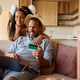 Happy couple using credit card and laptop while making online summer vacation reservation. Happy couple using credit card and laptop while making online summer vacation reservation. - PhotoDune Item for Sale