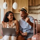 Happy couple celebrating after booking their summer vacation online. Happy couple celebrating after booking their summer vacation online. - PhotoDune Item for Sale
