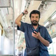 Indonesian Man Using Smartphone While Standing Inside KRL Train Indonesian Man Using Smartphone While Standing Inside KRL Train - PhotoDune Item for Sale