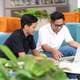 Two Men Discussing Work on Laptop in Modern Office Lounge Two Men Discussing Work on Laptop in Modern Office Lounge - PhotoDune Item for Sale