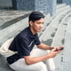 Asian Indonesian Man Using Smartphone Sitting on Urban Building Steps Asian Indonesian Man Using Smartphone Sitting on Urban Building Steps - PhotoDune Item for Sale