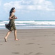 Young Woman Walking Along Beach Shoreline in Tropical Destination Young Woman Walking Along Beach Shoreline in Tropical Destination - PhotoDune Item for Sale
