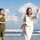 Happy Friends Walking on Parangtritis Beach Under Blue Sky Happy Friends Walking on Parangtritis Beach Under Blue Sky - PhotoDune Item for Sale