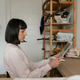 Woman focused on tablet with stylus in a calm home office workspace for remote work and creativity Woman focused on tablet with stylus in a calm home office workspace for remote work and creativity - PhotoDune Item for Sale