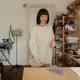Woman dusting and tidying her craft studio workspace in a cozy home sewing room Woman dusting and tidying her craft studio workspace in a cozy home sewing room - PhotoDune Item for Sale