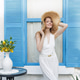 Woman in White Dress with Straw Hat by Blue Shuttered Window Woman in White Dress with Straw Hat by Blue Shuttered Window - PhotoDune Item for Sale
