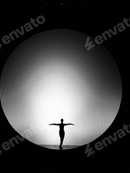 Silhouette of a dancer in front of circular light 2 E113NNU8.jpg?w=350&h=350&cf fit=scale down&mark=https%3A%2F%2Fassets.market storefront.envato static.com%2Fwatermarks%2Fphoto 260724