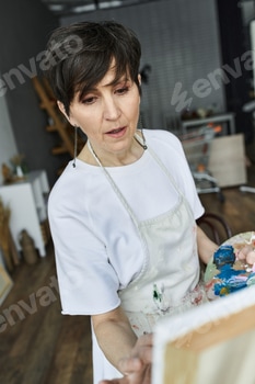 Mature woman passionately creating art in her bright and lively studio during the afternoon 2 E11DARP.jpg?w=350&h=350&cf fit=scale down&mark=https%3A%2F%2Fassets.market storefront.envato static.com%2Fwatermarks%2Fphoto 260724
