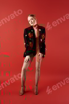 A young woman adorned with flowers poses gracefully against a vibrant red backdrop 2 E11D7EJ.jpg?w=350&h=350&cf fit=scale down&mark=https%3A%2F%2Fassets.market storefront.envato static.com%2Fwatermarks%2Fphoto 260724